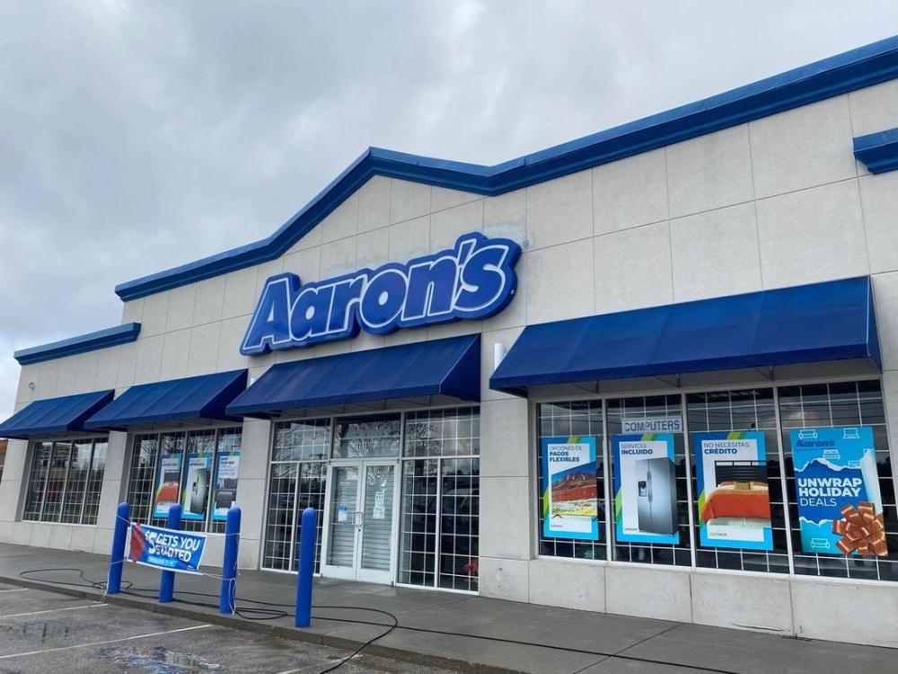Clean commercial storefront with awnings and clear glass after exterior washing