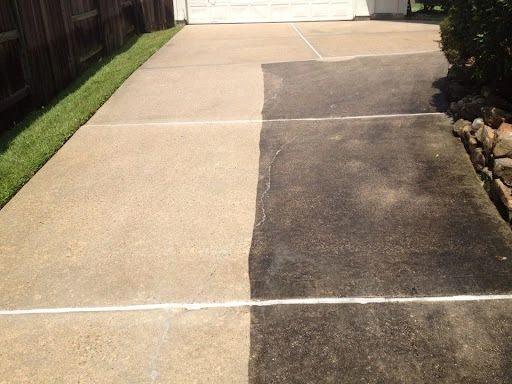 Concrete walkway with one half pressure washed clean and the other still stained